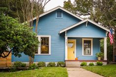 a blue house with an american flag on the front door