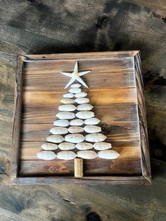 a christmas tree made out of rocks in a wooden box on top of wood planks