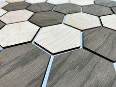 a close up view of some wood tiles on the floor with hexagonal shapes