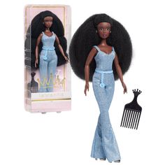 a barbie doll with an afro and hair comb in front of a package for dolls