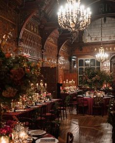 an ornate dining room with chandeliers and tables set for dinner in the center