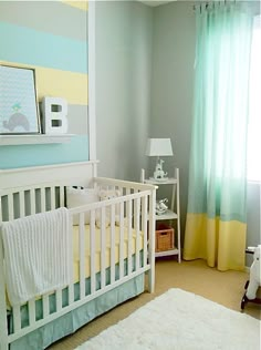 a baby's room with blue, yellow and white decor