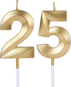 two candles with the number twenty five in gold and white frosting, on top of each other