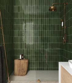 a green tiled bathroom with wooden standup shower