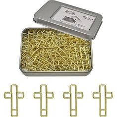 a tin with some gold colored pins in it next to other metal clips and magnets