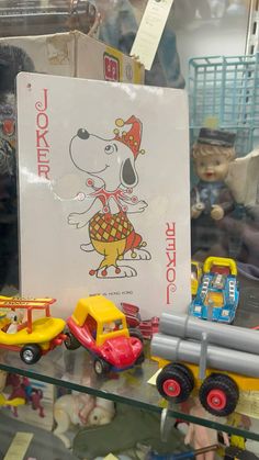 a display case filled with toys and other items on top of a glass shelf in a store