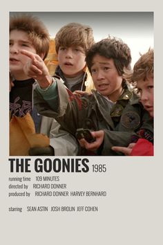 the goonies movie poster with young boys pointing at something in front of their faces