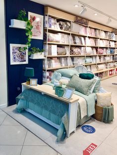 a room filled with lots of furniture and bookshelves full of books on shelves