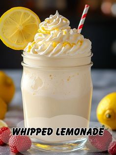 whipped lemonade in a mason jar with strawberries and lemons around the rim