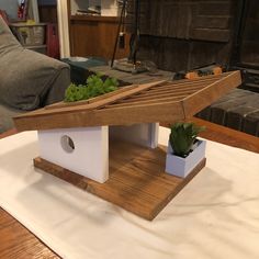 a house shaped planter sitting on top of a table