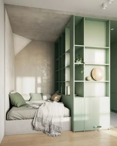 a bedroom with a bed, bookcases and shelves in the wall next to it