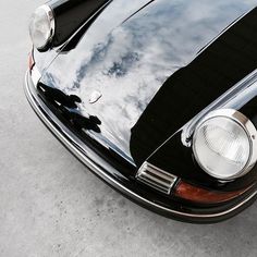 the front end of an old black car