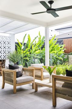 an outdoor living area with furniture and plants