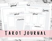 the printable tarot journal is on top of a marble surface