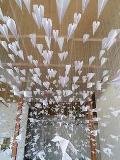 an image of some white paper flying in the air over a room full of mirrors