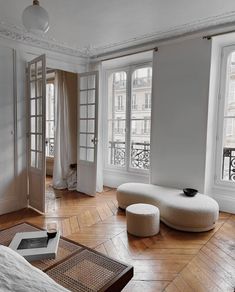 a living room filled with furniture and windows