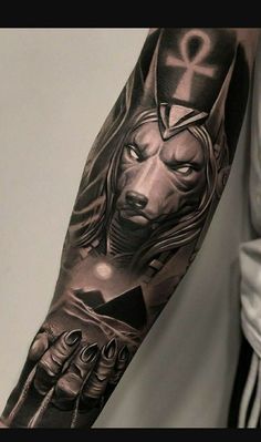 a man's arm with tattoos on it and an image of a wolf in the middle