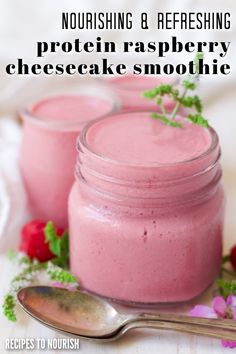 Photo of a small glass jar filled with a pink smoothie, garnished with a green and white flower, sitting next to a fresh raspberries, pink flowers and white and green flowers around it, silver spoons in front of it an a couple small jars filled with the pink smoothie in the background with text that says Nourishing & Refreshing Protein Raspberry Cheesecake Smoothie. Raspberry Smoothie, Raspberry Cheesecake, Healthy Alternatives, High Protein, Smoothie Recipes, Cheesecake, Raspberry, Fruit