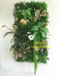 a white brick wall covered in plants and flowers