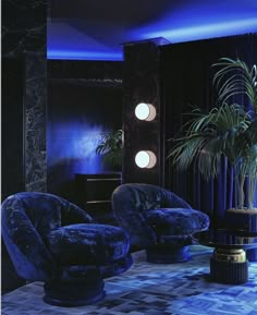 a living room filled with furniture and blue lighting