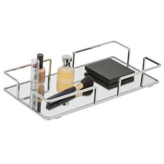 a metal tray with makeup and cosmetics on it