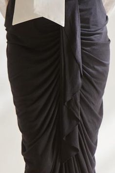 Black skirt with draped and gathers detail.
Component: 1
Fabric: Viscose
Color: Black
Closure: Back zip
Note: Top worn by the model is not for sale - Aza Fashions Draped Skirt With Ruched Sides For Evening, Black Formal Draped Skirt, Fitted Draped Skirt With Ruched Sides, Black Draped Bottoms For Evening, Fitted Long Draped Skirt With Folds, Elegant Draped Bottoms With Ruched Sides, Elegant Black Draped Bottoms, Black Draped Ruched Bottoms, Black Draped Ruched Skirt