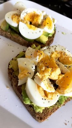 two pieces of bread with hard boiled eggs and avocado