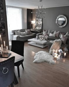 a living room filled with furniture and candles