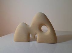 two white sculptures sitting on top of a table