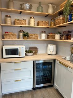 a kitchen with white cabinets and open shelves