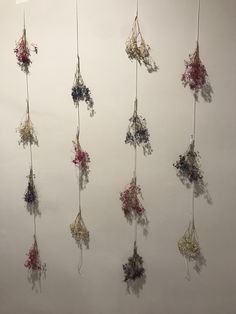 there are many flowers hanging on the wall