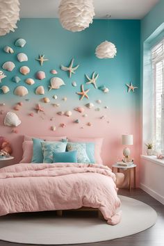 a pink and blue bedroom with sea shells on the wall