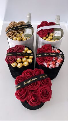 four buckets filled with roses and chocolates