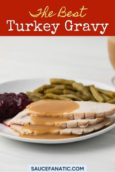 turkey gravy on a plate with green beans and cranberry sauce