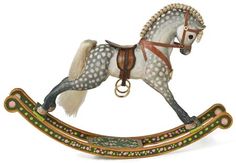 a toy rocking horse with white and brown spots on it's body, standing upright