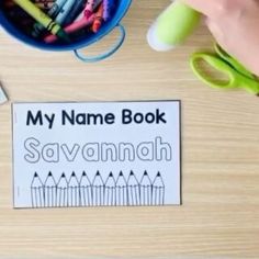 the name book savannah is next to some crayons and scissors on a table