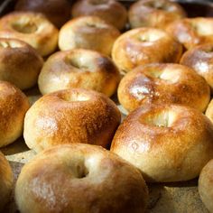 freshly baked bagels are lined up on a baking sheet