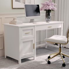 a white desk with a computer on it and a chair in front of the desk