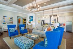 a living room filled with furniture and a chandelier