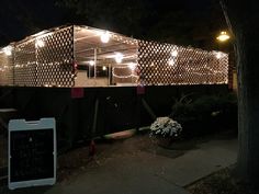 a small building with lights on it at night