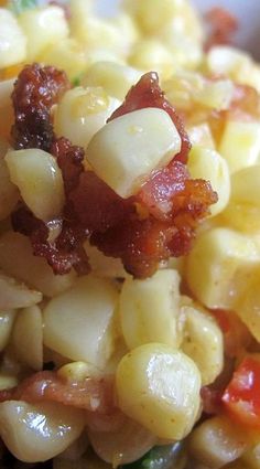 a close up view of corn with bacon on top and green beans in the middle