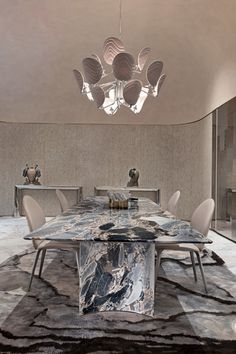 a dining room with marble table and chairs