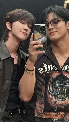 two young men taking a selfie with their cell phones