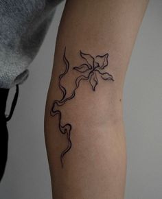 a woman's arm with a tattoo design on the left side of her body