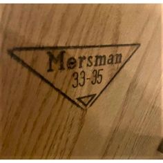 a close up of a wooden object with the name mersman on it's side