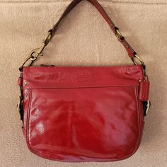 New Vintage Coach Patent Leather Red "Zoe" Bag. 100% Authentic. Amazing Color That Will Make Your Jaw Drop In A Classic And Sophisticated Style!! Features Zip Top Opening, Great Chunky Bronze Hardware, Large Satin-Like Tan Interior Lining With Plenty Of Pockets And Space. Size Is 12 (W) X 9.5(H) X 3.5(D). New, Never Used, No Tags, Comes With Dust Bag And Care Instructions. Comes From Smoke Free Home. Red Coach Satchel, Modern Red Shoulder Bag With Gold-tone Hardware, Luxury Red Satchel Hobo Bag, Chic Red Coach Bag, Chic Red Top Handle Hobo Bag, Formal Red Coach Shoulder Bag, Formal Red Hobo Bag, Coach Red Evening Bag, Red Coach Shoulder Bag For Evening