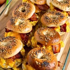 bagels with bacon, eggs and cheese on them