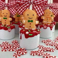 gingerbread cupcakes are decorated with candy canes and bow ties on top