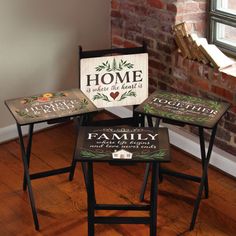 three stools with signs on them sitting in front of a brick wall and window