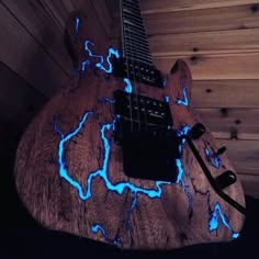 an electric guitar with blue lights on it